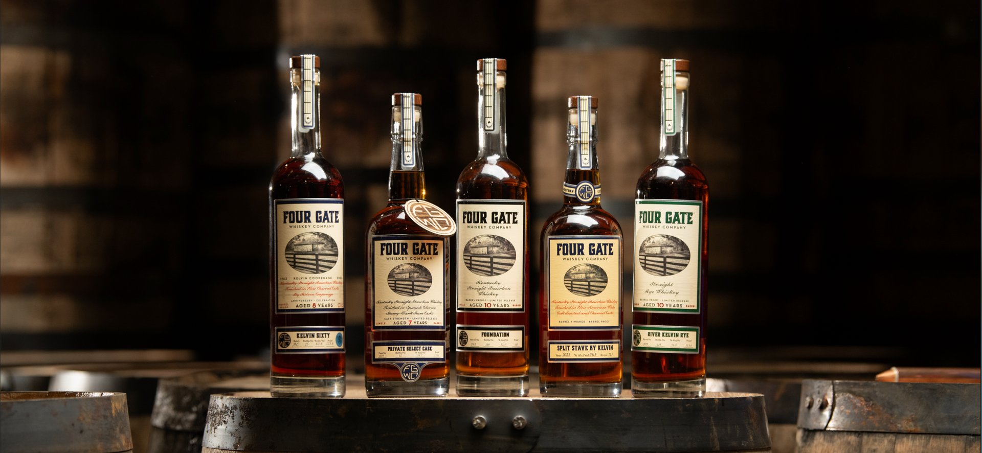 Five Four Gate bottles lined up on a barrel head